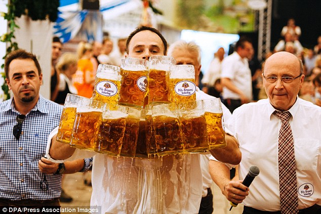 德国酒保捧27杯一公升啤酒，行40米路刷新世界纪录。网上图片