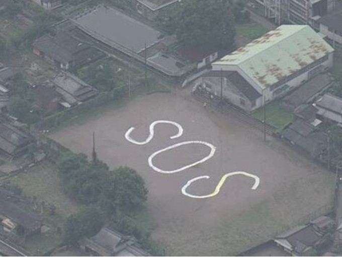 八代市坂本町有居民在地上寫上SOS字樣求援。NHK截圖