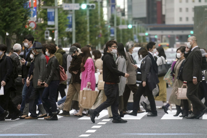 日本下调中国等9个国家及地区的疫情警戒级别。 AP图