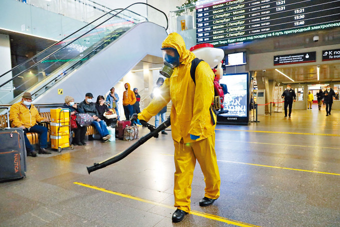 衞生人员周二在莫斯科列宁格勒火车站消毒。