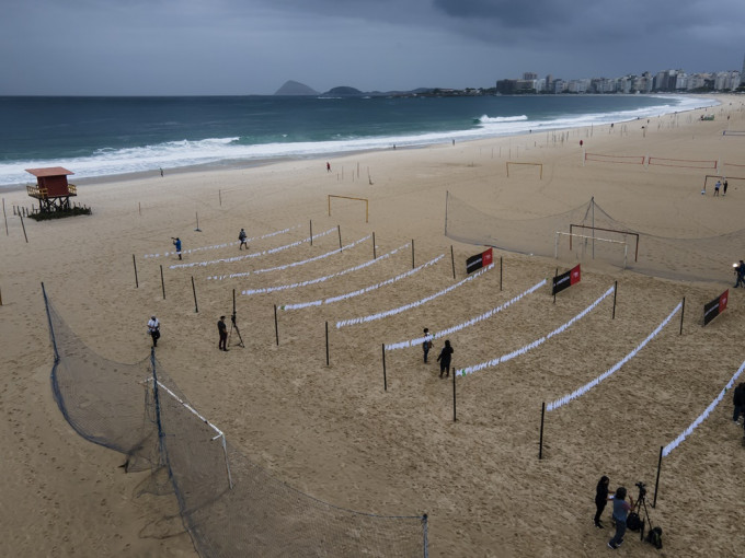 有团体在里约热内卢的海滩拉起布条，悼念新冠疫情中的死者。路透社图片