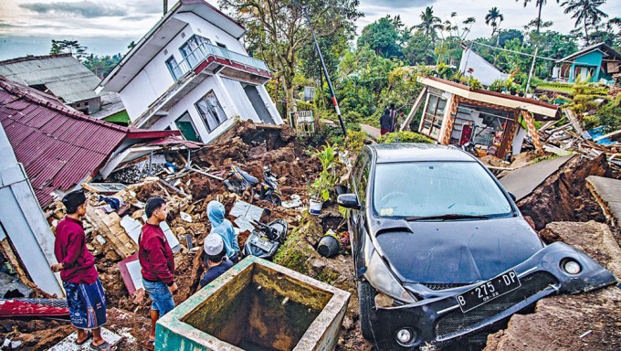 展玉災區的村民，在地震損毀的房屋中找尋有用物品。