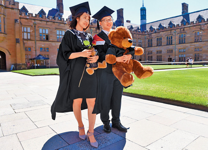 两名来自中国的留学生，在悉尼大学完成一个商业课程后，在校园拍照留念。