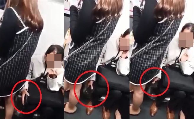 片中可见一名中年男子在港铁车厢内，疑用手机偷拍一名站在其身旁女士的裙底。影片截图
