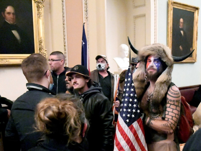 钱斯利戴上牛角帽披上熊皮头饰冲击华盛顿国会山庄。REUTERS