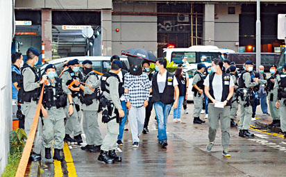 ■涉嫌主犯被蒙頭押往西九龍中心一帶重組案情。