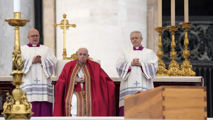 在梵蒂冈举行的葬礼弥撒中，教宗方济各坐在圣彼得广场已故荣休教宗本笃十六世的棺材旁。AP