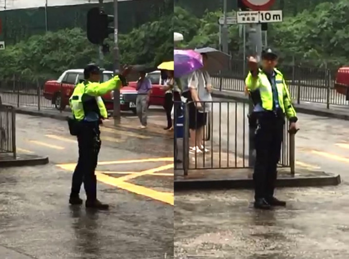 兩名交通警冒雨指揮交通約半小時。影片截圖
