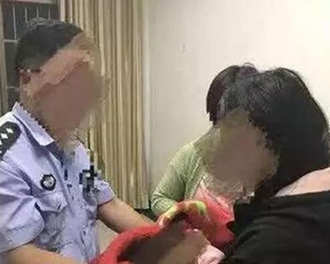 警方将被拐卖女婴交还给家人。网图