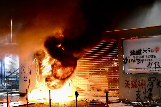 示威者放火燒小米店鋪。