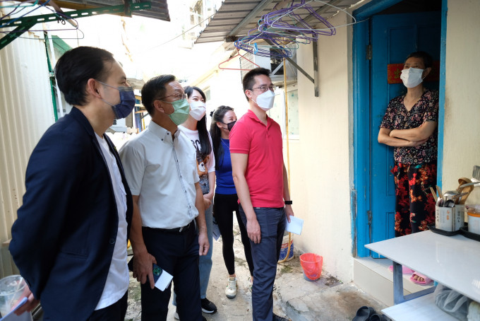 刘业强与郭基辉及杨政龙等人，带领20名青年学员到屯门寮屋区探访基层家庭。