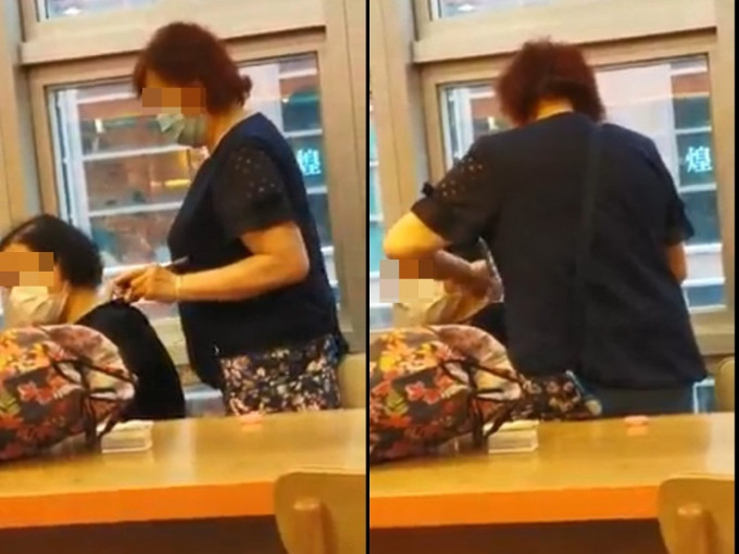 兩名中年女子在一間餐廳內刮痧。影片截圖