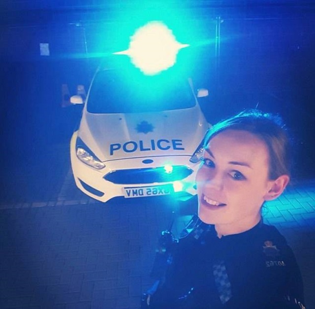 新紥师姐宾克西身穿制服，在一辆警车前自拍。