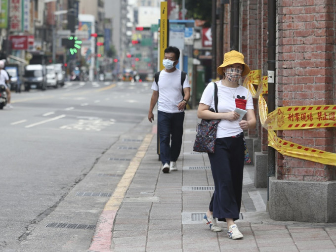 3級防疫警戒下所有民眾出外必須戴口罩。AP