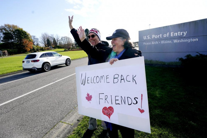 美国和加拿大双重公民 和她的美国丈夫在华盛顿州布莱恩举著一个自制的标语欢迎人们从加拿大前往美国。AP图片
