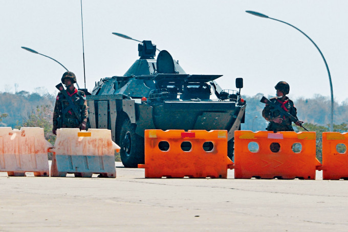 在通往首都奈比都国会的路上，周一有士兵在路障前站岗。