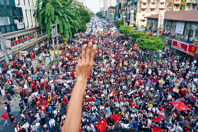■大批示威者周六在仰光游行，有民众举三指抗议军方夺权。