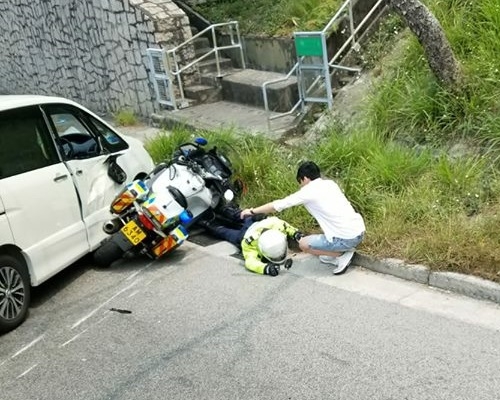 交通警倒卧地上，被翻側的電單車壓着。fb群組「香港交通突發報料區」圖片
