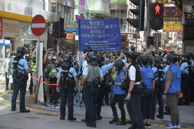 警方舉藍旗警告遊行人士。