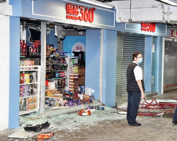 橱窗玻璃碎片与店内货物散落一地，部分货物被烧毁。