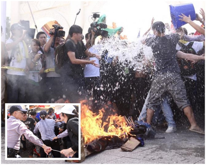 示威團體焚燒紙紮人偶遭警方制止。網上圖片
