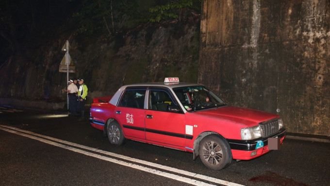 警員到場調查事件，的士車頭遺下一灘血跡。