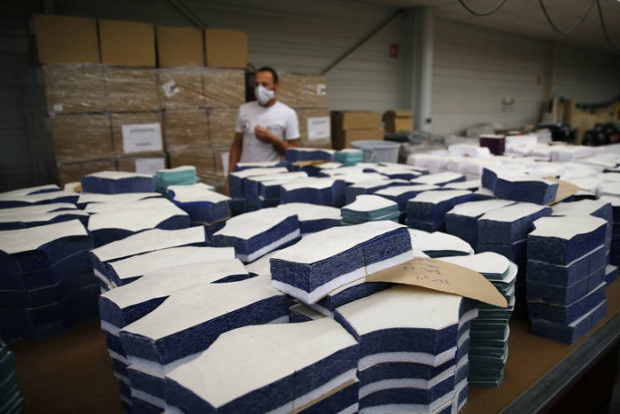 法国很多制衣厂响应政府号召暂停正常生产，改制造布口罩「救国」，如今却出现滞销。AP图