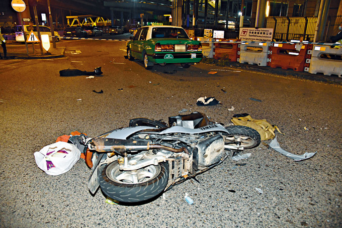 電單車撞的士後，全車翻側損毀嚴重。