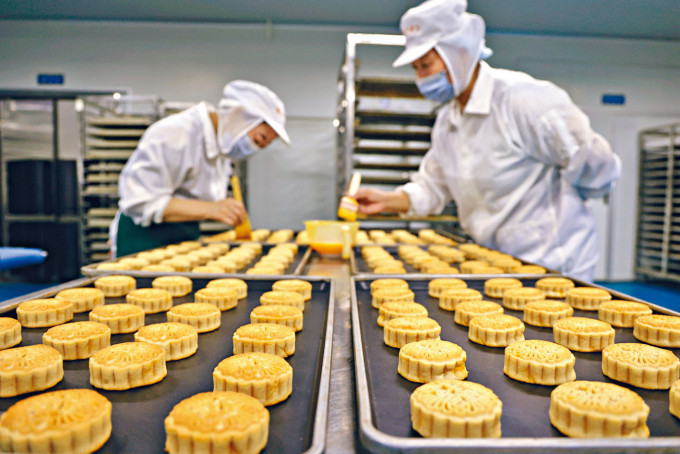 ■工人在山東省濱州市高新區一家食品企業車間生產月餅等工作。