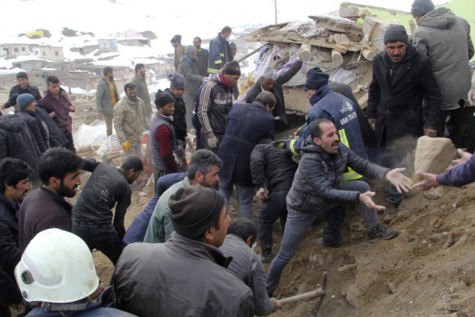 在土耳其凡城省，民众尝试掘开瓦砾救出被活埋的人，山区的村庄损毁严重。AP