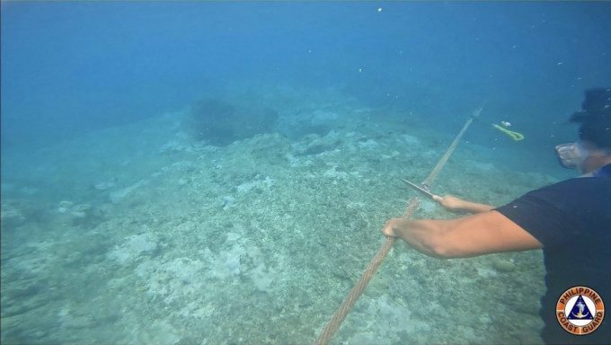 菲律賓海岸警衛隊上月發布圖片，指潛水員拆除了中方設置的浮動屏障。 美聯社