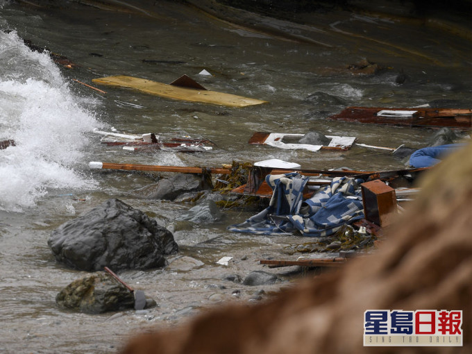 在聖地亞哥海岸附近一艘船隻翻覆，殘骸被衝上岸。AP圖片
