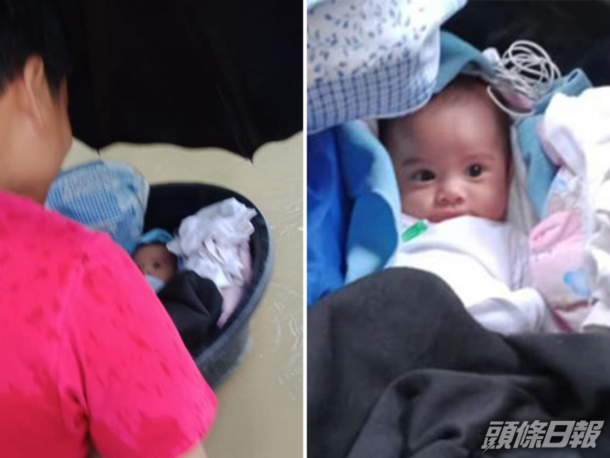 颱風吹襲多處水浸,馬尼拉一名母親將3個月大B女放浴盆運到安全地方。