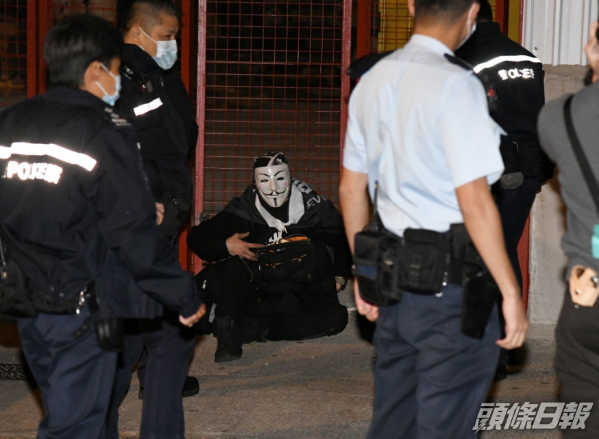 施景騫上周六凌晨在旺角戴上「V煞」面具及披著寫上「光復香港 時代革命」字句的披肩,被警方拘捕。資料圖片