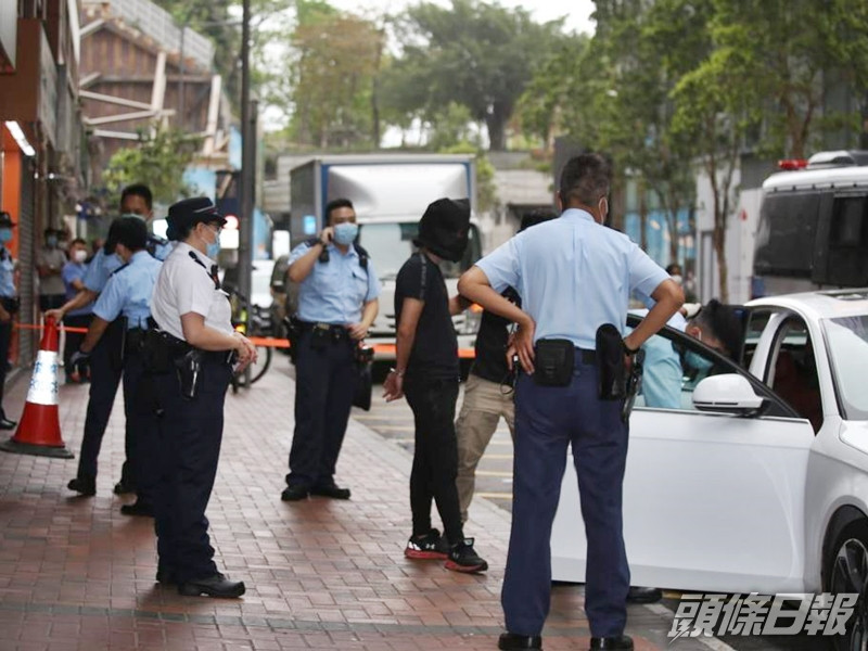 警方為被捕男子戴上頭套,其後將他們押往一輛私家車旁調查。