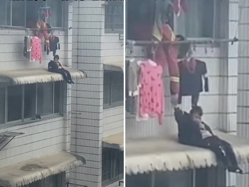 消防一手拉回跌坐至簷篷的男孩。(網圖)